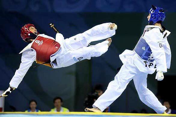 Gabriel Mercedes of the Dominican Republic tries a flying kick against Shu-Chun Yang of Taiwan in the 58kg quarterfinals of taekwondo at the 2008 Beijing Olympics. Best of 2008 Photography >>> Best of 2008 Main >>>