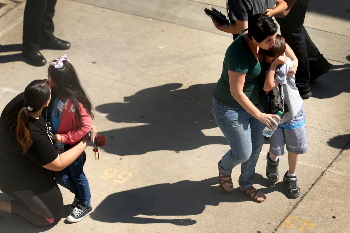 Parents are reunited with their children at Cajon High School after a school shooting at North Park Elementary School in San Bernardino.