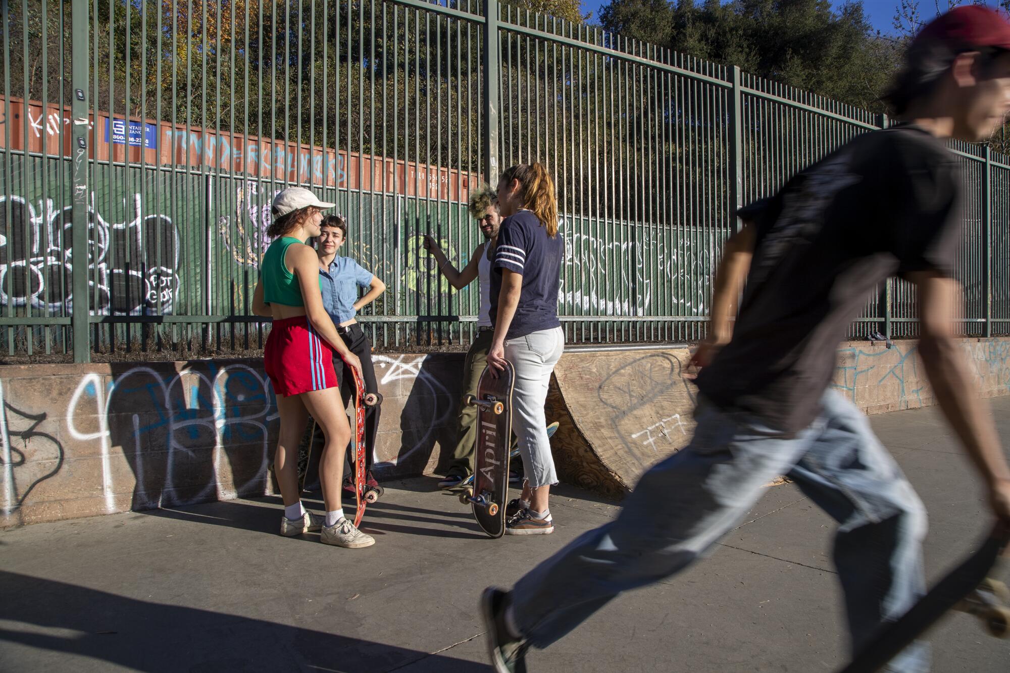 SOUTH PASADENA, CA - November 14 2021: Members of the Aunt Skatie crew, left, gather.