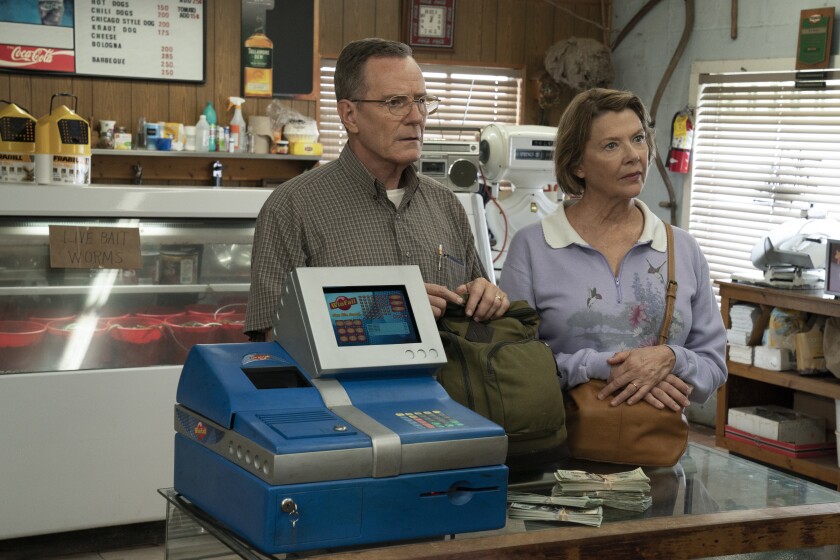 A man and a woman stand at a convenience store counter.