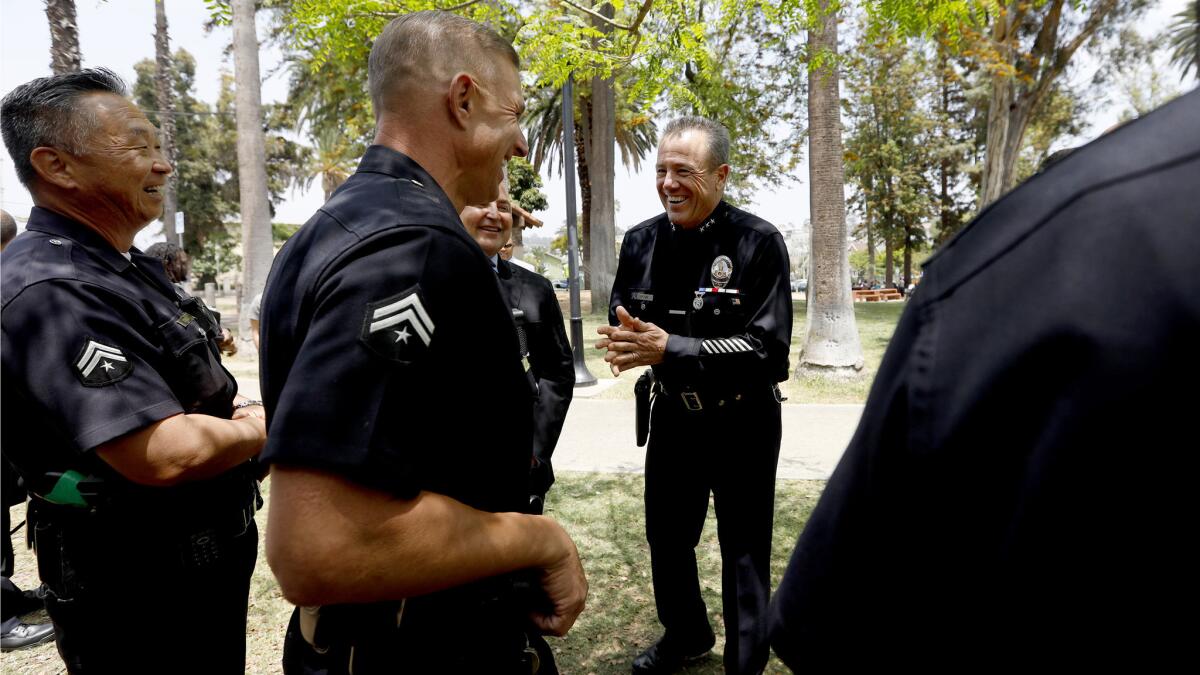 LAPD veteran Michel Moore, center, jokes with the other LAPD officers before speaking at a press conference in Echo Park.