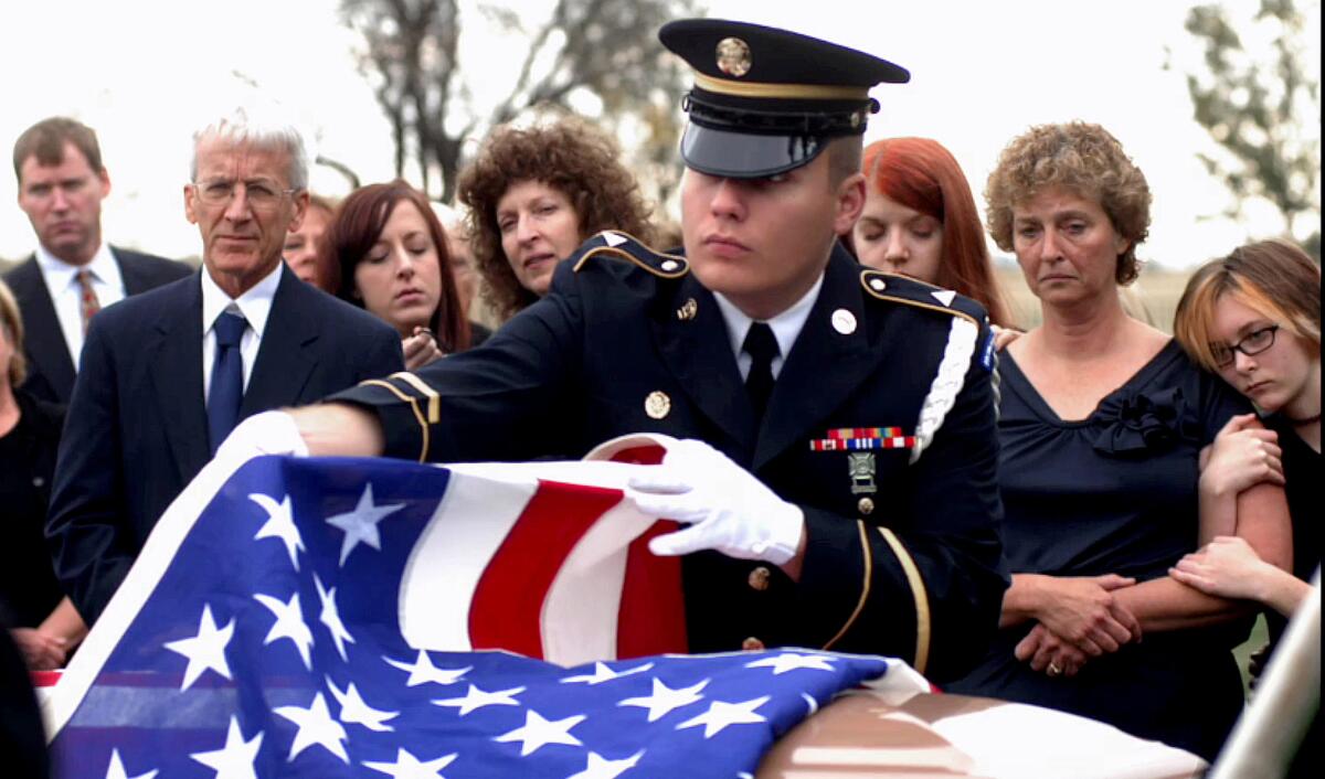 Ray Alkofer's family gathers at the Park River, N.D. cemetery.