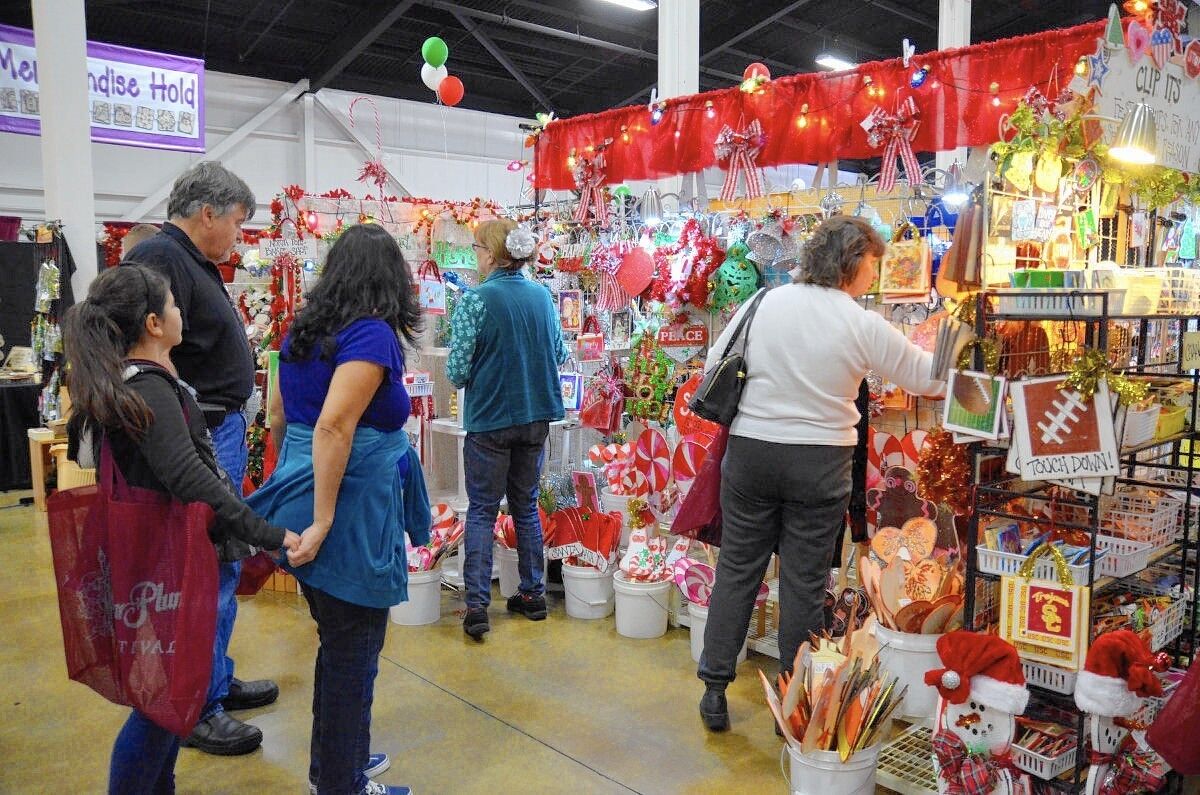 Shoppers browse crafts during the 2014 Sugar Plum Festival at the OC Fair & Event Center.