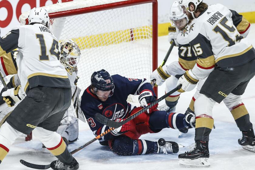 Winnipeg Jets' Tyler Toffoli gets hit by a shot in front of Vegas Golden Knights goaltender Logan Thompson during the first period of an NHL hockey game in Winnipeg, Manitoba, on Thursday, March 28, 2024. (John Woods/The Canadian Press via AP)