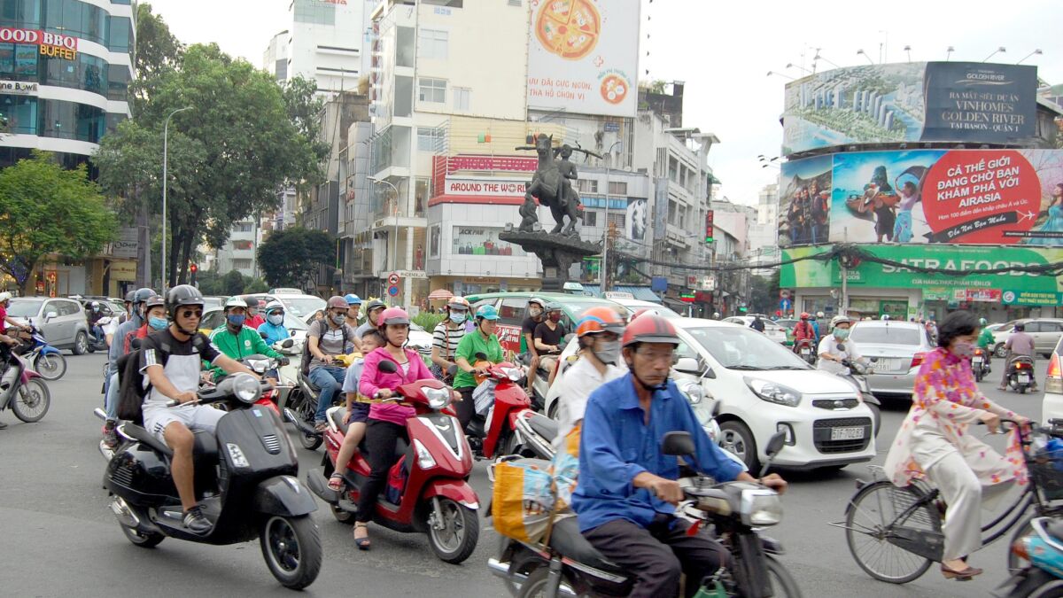 Motorcycles course through downtown Ho Chi Minh City, where coffee roasters and tech startups are now wedged in between noodle soup vendors and bike repairmen.