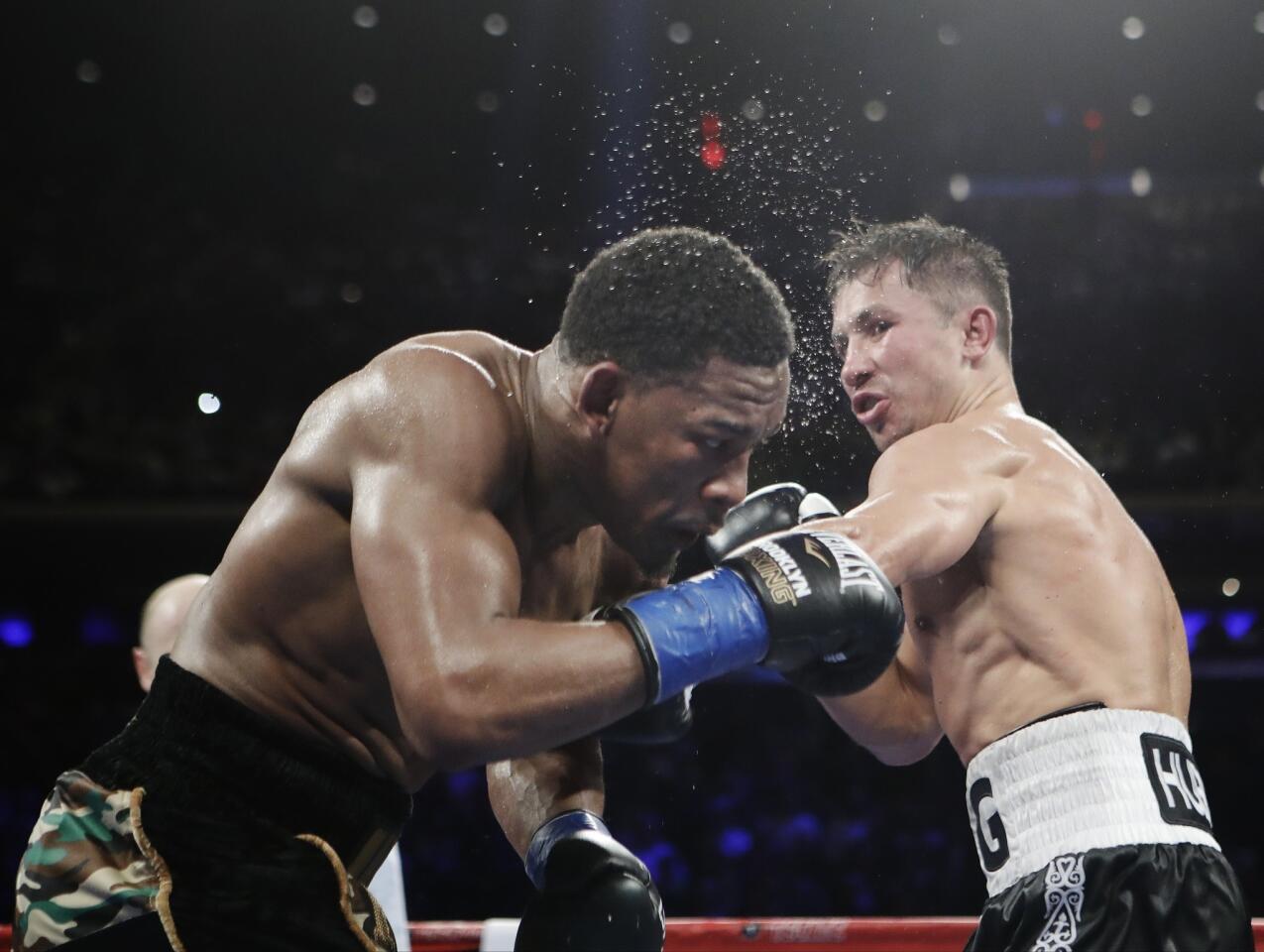 Gennady Golovkin, right, of Kazakhstan, hits Daniel Jacobs during the 12th round of a middleweight boxing match early Sunday, March 19, 2017, in New York. Golovkin won the fight. (AP Photo/Frank Franklin II)