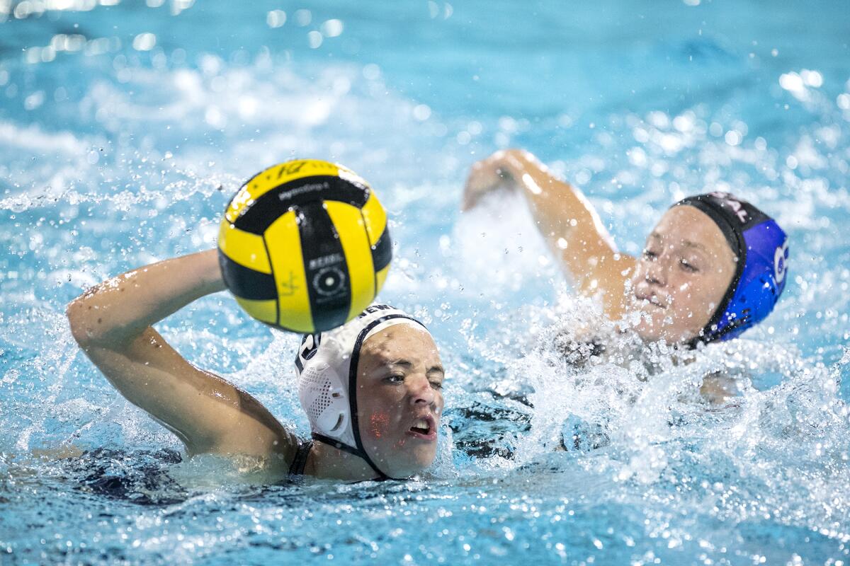 Newport Harbor's Kylie Robison battles for an open ball against Los Alamitos' Colleen Sorenson during Thursday's match.