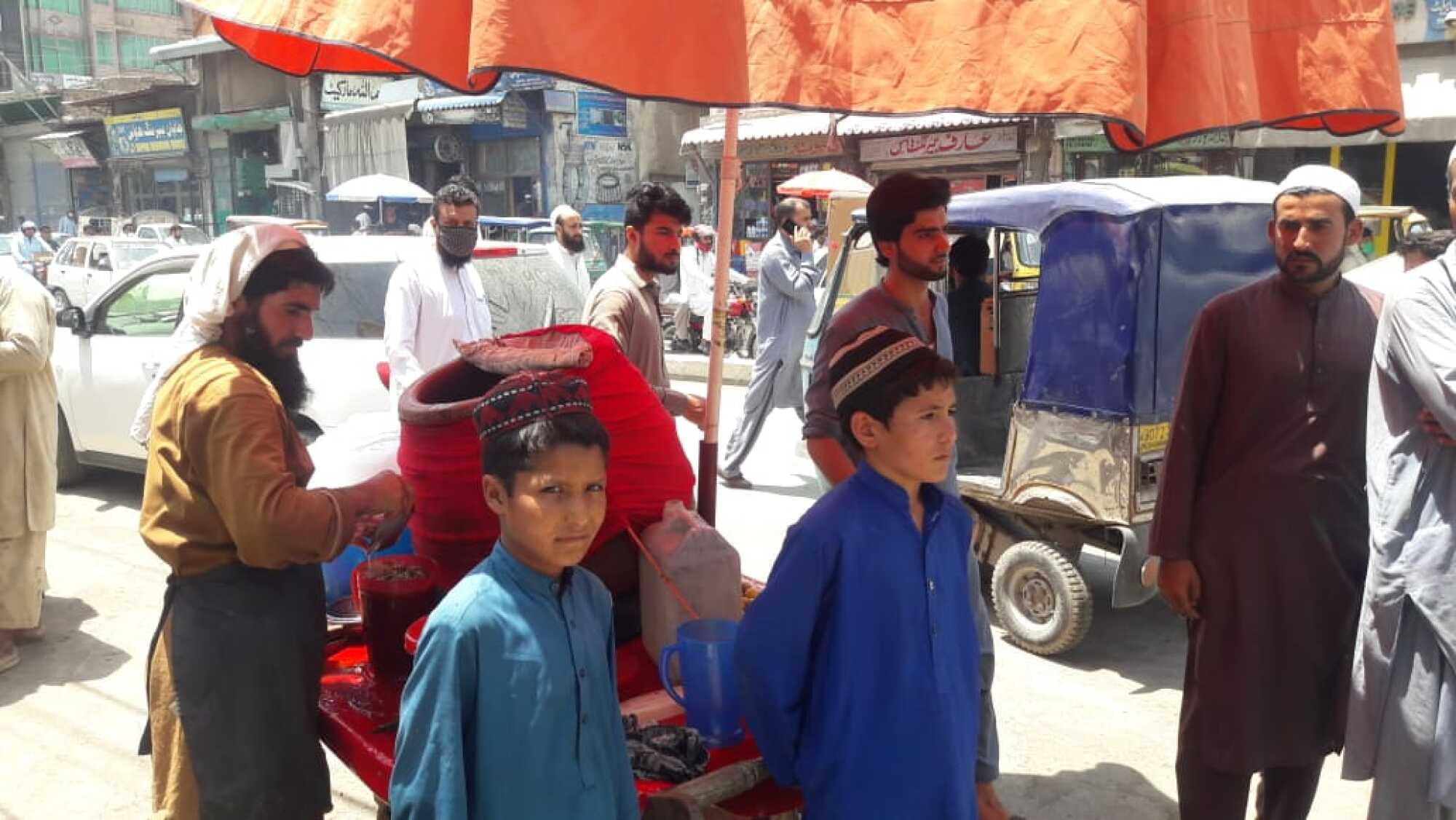 Umar Gul, left, and his cousin Muhammad Siraj work at a lemonade cart in Peshawar, Pakistan.