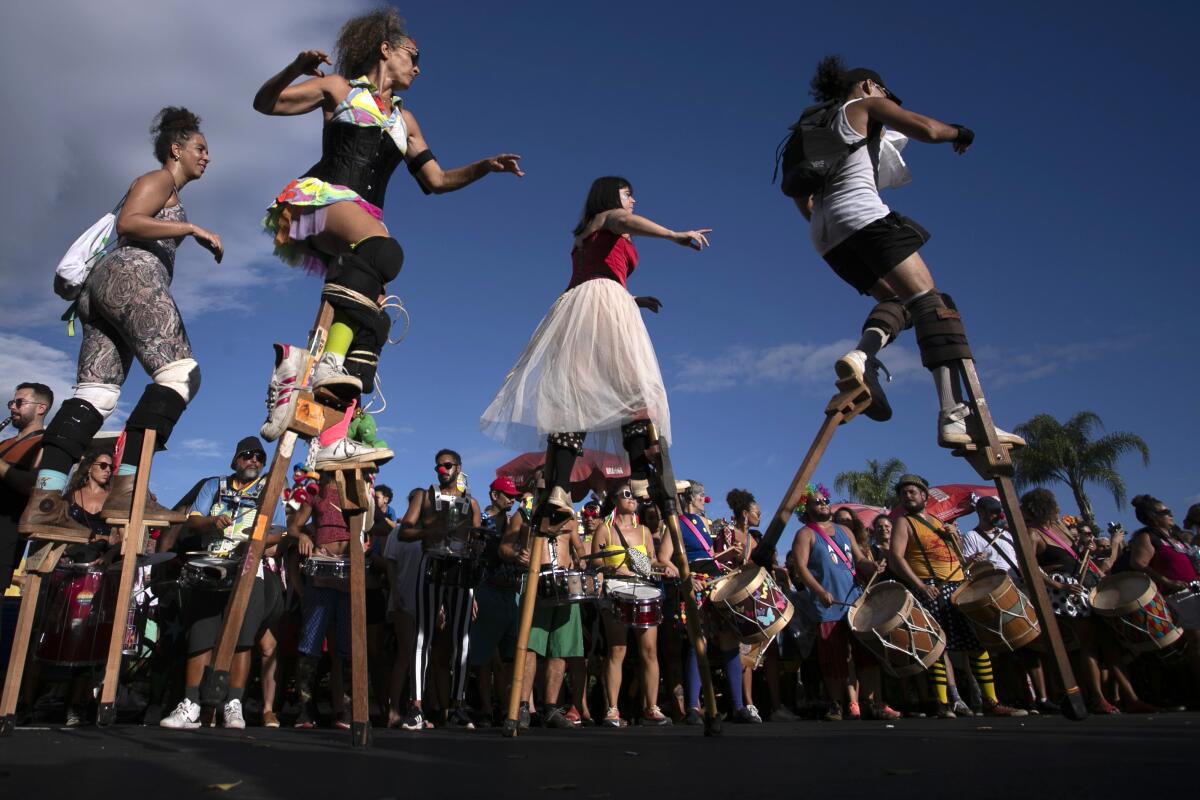 Revelers parade on wooden stilts during a pre-carnival street party rehearsal, in Rio de Janeiro, Brazil, Jan. 21, 2024. Brazilians are gearing up for this year's Carnival, scheduled from Feb. 9-17. (AP Photo/Bruna Prado)