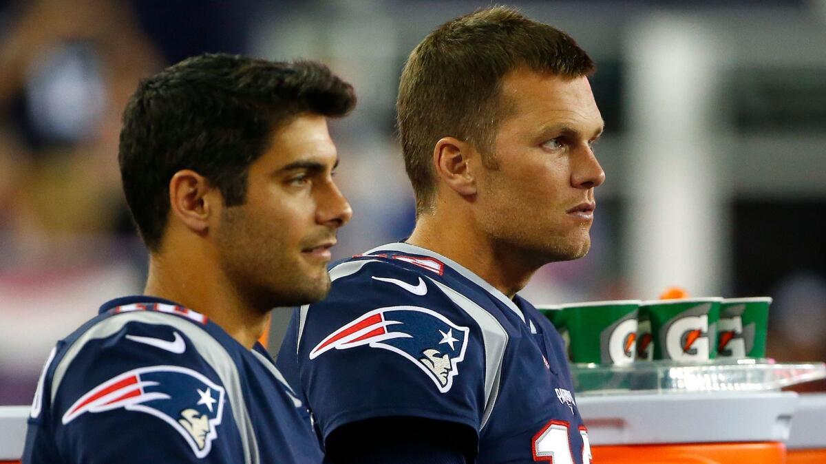 New England Patriots quarterbacks Tom Brady, right, and Jimmy Garoppolo look on during a preseason game against the New York Giants on Aug. 31.