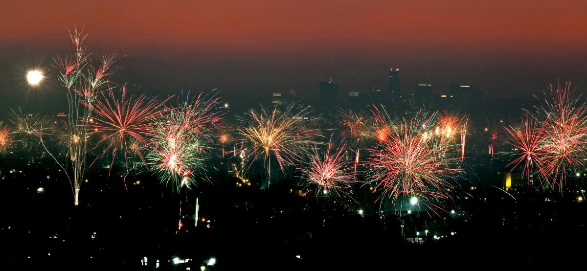 A hazy downtown Los Angeles behind Fourth of July fireworks