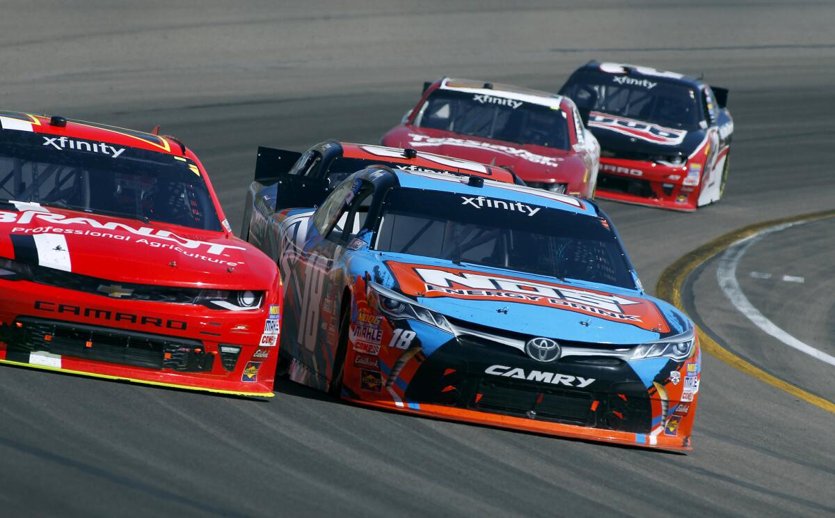 NASCAR driver Kyle Busch has the inside line against Justin Allgaier coming out of Turn 4 duirng the Xfinity Series race Saturday at Phoenix International Raceway.