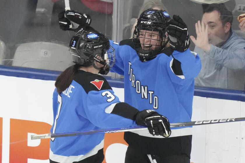 Toronto's Emma Maltais, right, celebrates with Jocelyne Larocque after scoring against Minnesota during the second period of Game 1 of a PWHL hockey playoffs semifinal Wednesday, May 8, 2024, in Toronto. (Chris Young/The Canadian Press via AP)