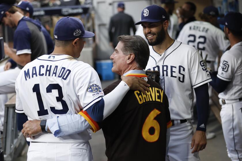 Former San Diego Padre Steve Garvey (6) greets third baseman Manny Machado (13) and first baseman Eric Hosmer, right, before the team's baseball game against the St. Louis Cardinals on Saturday, June 29, 2019, in San Diego. (AP Photo/Gregory Bull)