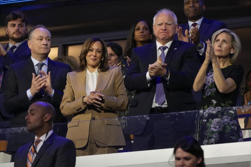 Democratic presidential nominee Vice President Kamala Harris, second gentleman Doug Emhoff, Democratic vice presidential candidate Minnesota Gov. Tim Walz and his wife Gwen Walz, attend the first day of Democratic National Convention, Monday, Aug. 19, 2024, in Chicago. (AP Photo/Jacquelyn Martin)