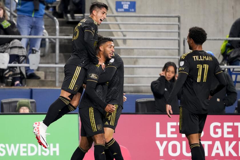 Los Angeles FC forward Cristian Olivera, left, jumps to celebrate with forward Denis Bouanga, second from left, and midfielder Timothy Tillman (11) after Bouanga scored against the Seattle Sounders during the first half of an MLS conference semifinal playoff soccer match Sunday, Nov. 26, 2023, in Seattle. (AP Photo/Lindsey Wasson)