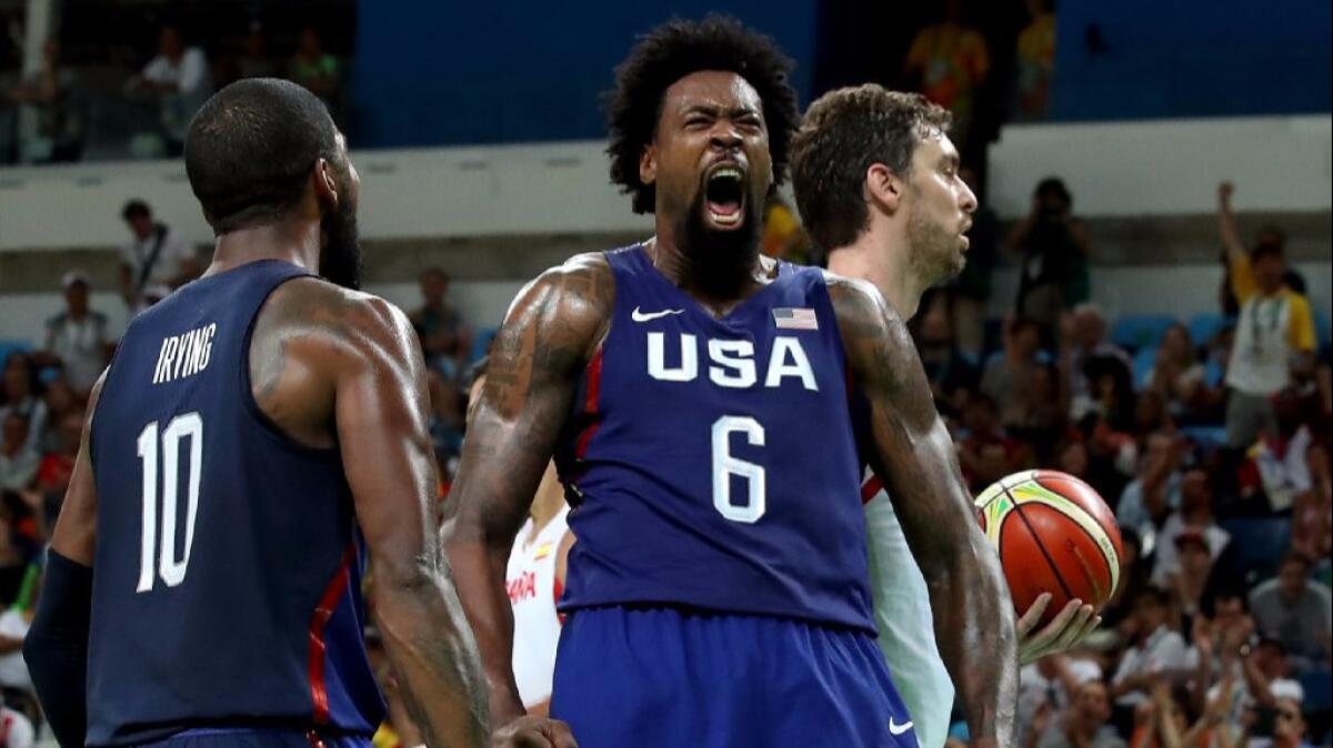 DeAndre Jordan yells after getting a rebound and slamming it as Spain's Pau Gasol, right, looks on during a semifinal game at the 2016 Summer Games.