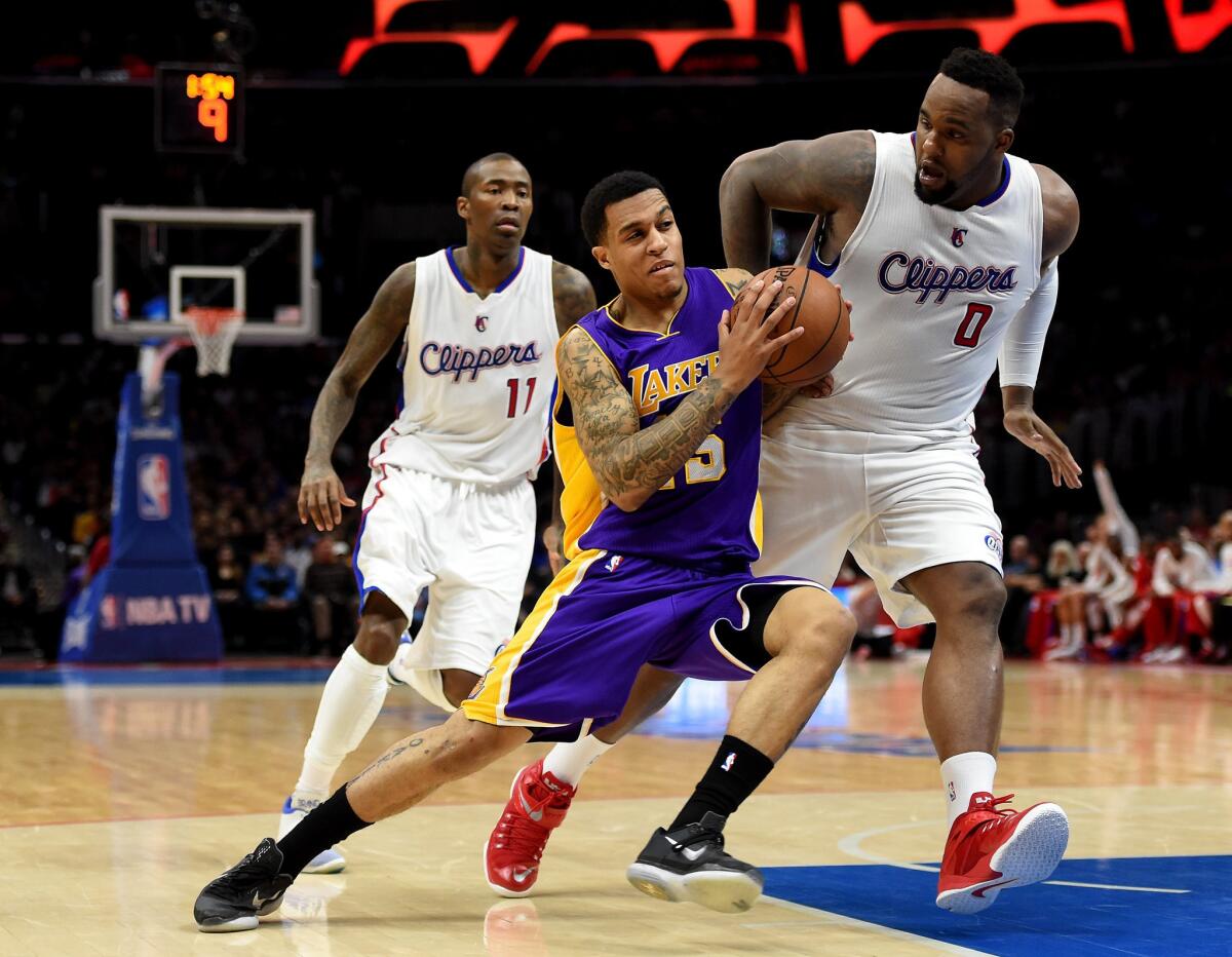 Lakers guard Jabari Brown drives to the hoop against Clippers center Glen Davis during the first half of a game April 7 at Staples Center.