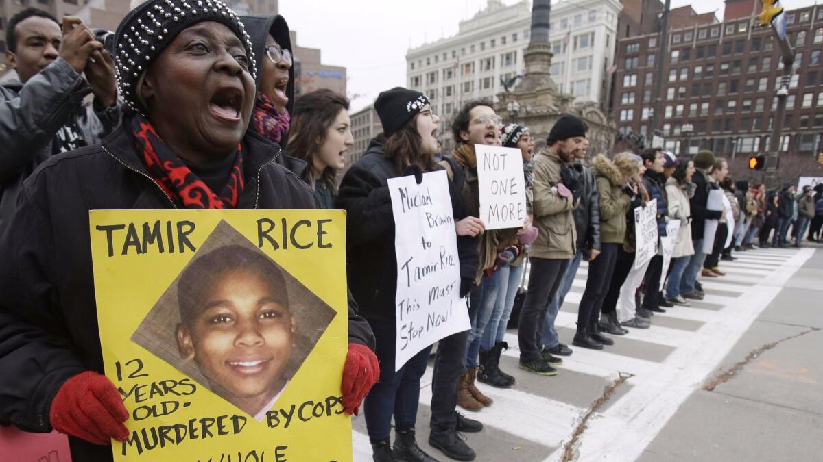 Demonstrators in Cleveland protest the shooting of Tamir Rice. "The Hate U Give" has been called a "Black Lives Matter novel."