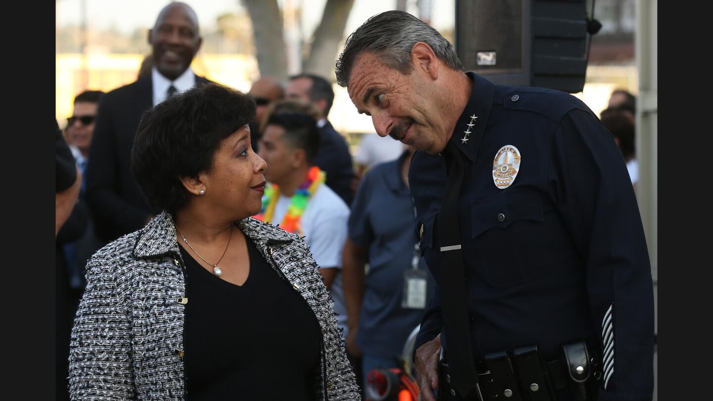 U.S. Atty. Gen. Loretta Lynch and LAPD Chief Charlie Beck chat during opening night of the city’s Summer Night Lights program at Highland Park Recreation Center. Her visit to L.A. was part of a six-city tour.