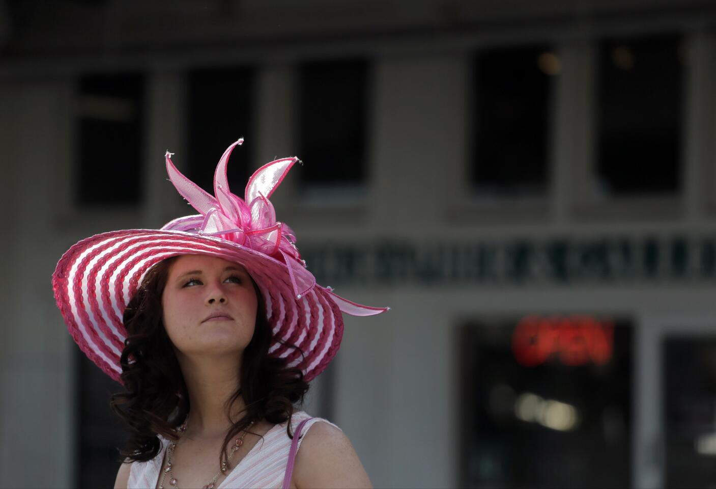 A woman looks over the paddock area before the 141st running of the Kentucky Derby horse race at Churchill Downs Saturday.