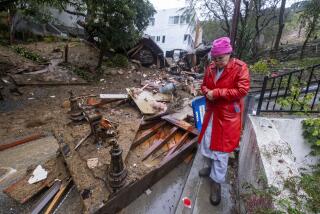 A resident walks by a destroyed home.