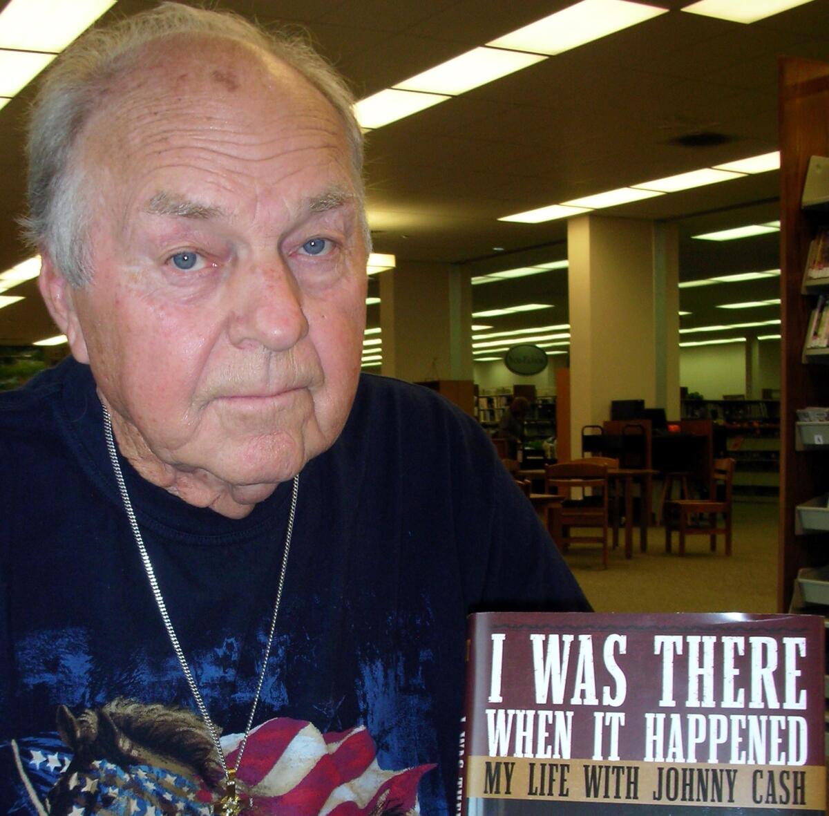 Marshall Grant poses with a copy of his book, "I Was There When It Happened: My Life with Johnny Cash," in 2007.