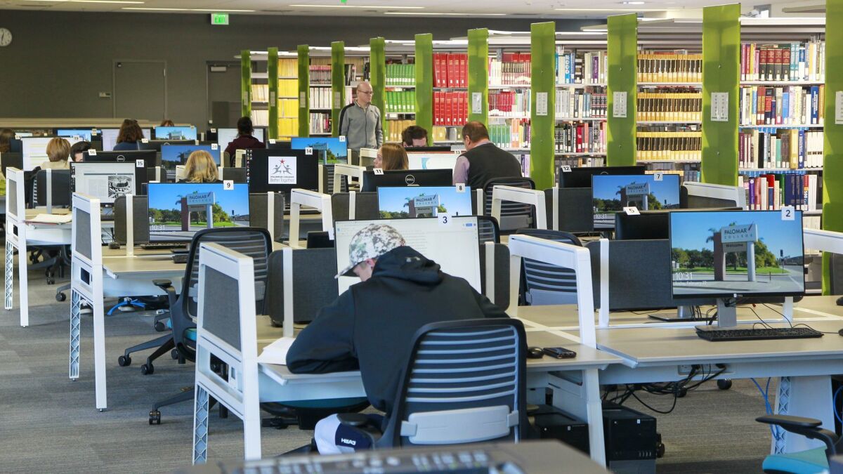 Students work in the reference library and computer room on the first floor of the new library at Palomar College in San Marcos.