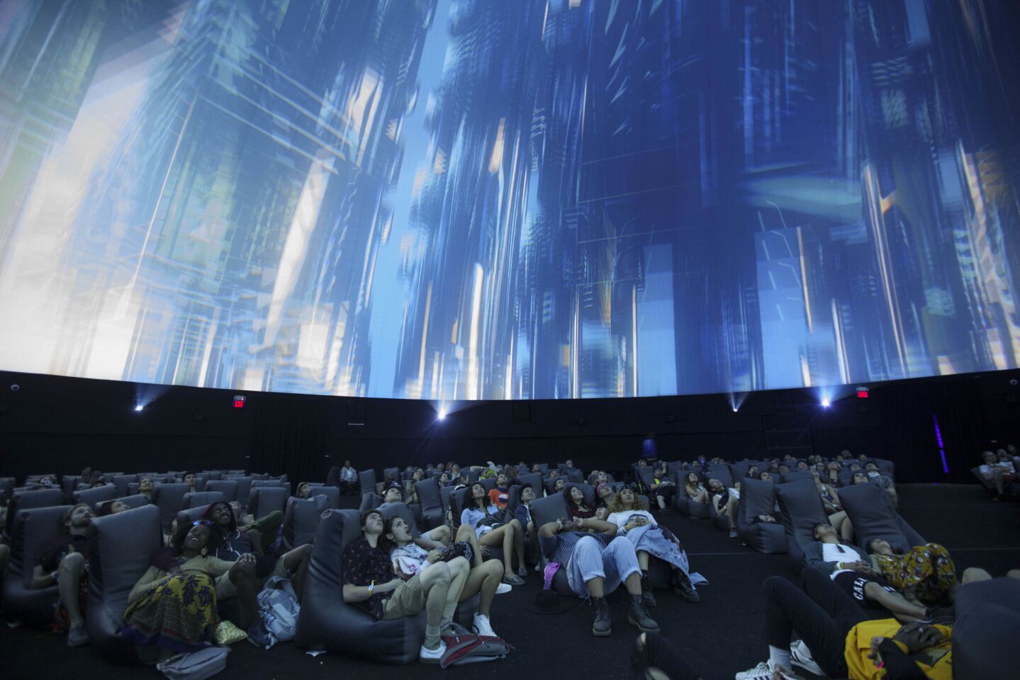 Attendees watch The Antarctic powered by HP, a 360 degree sensory experience inside a large-scale projection dome during weekend one of the three-day Coachella Valley Music and Arts Festival at the Empire Polo Grounds on Saturday, April 15, 2017 in Indio, Calif. (Patrick T. Fallon/ For The Los Angeles Times)