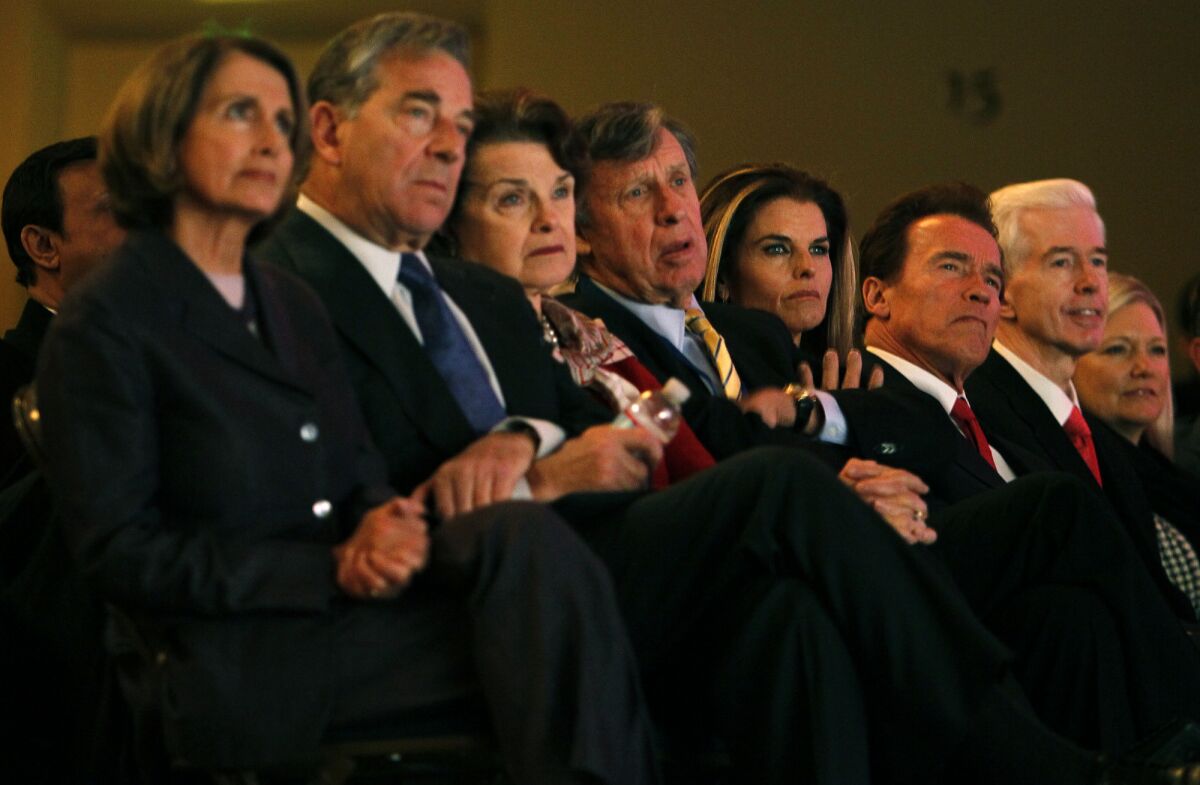 In this 2011 photo, Sen. Dianne Feinstein and Richard Blum (center) watch Gov. Jerry Brown's inauguration with other California political figures.