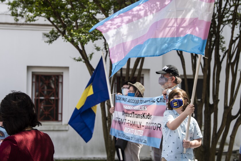 FILE - Protestors in support of transgender rights rally outside the Alabama State House in Montgomery, Ala., March 30, 2021. Three days after the U.S. Supreme Court ruled that states can prohibit abortion, Alabama seized on the decision to argue that the state should also be able to ban gender-affirming medical treatments for transgender youth. (Jake Crandall/The Montgomery Advertiser via AP, File)