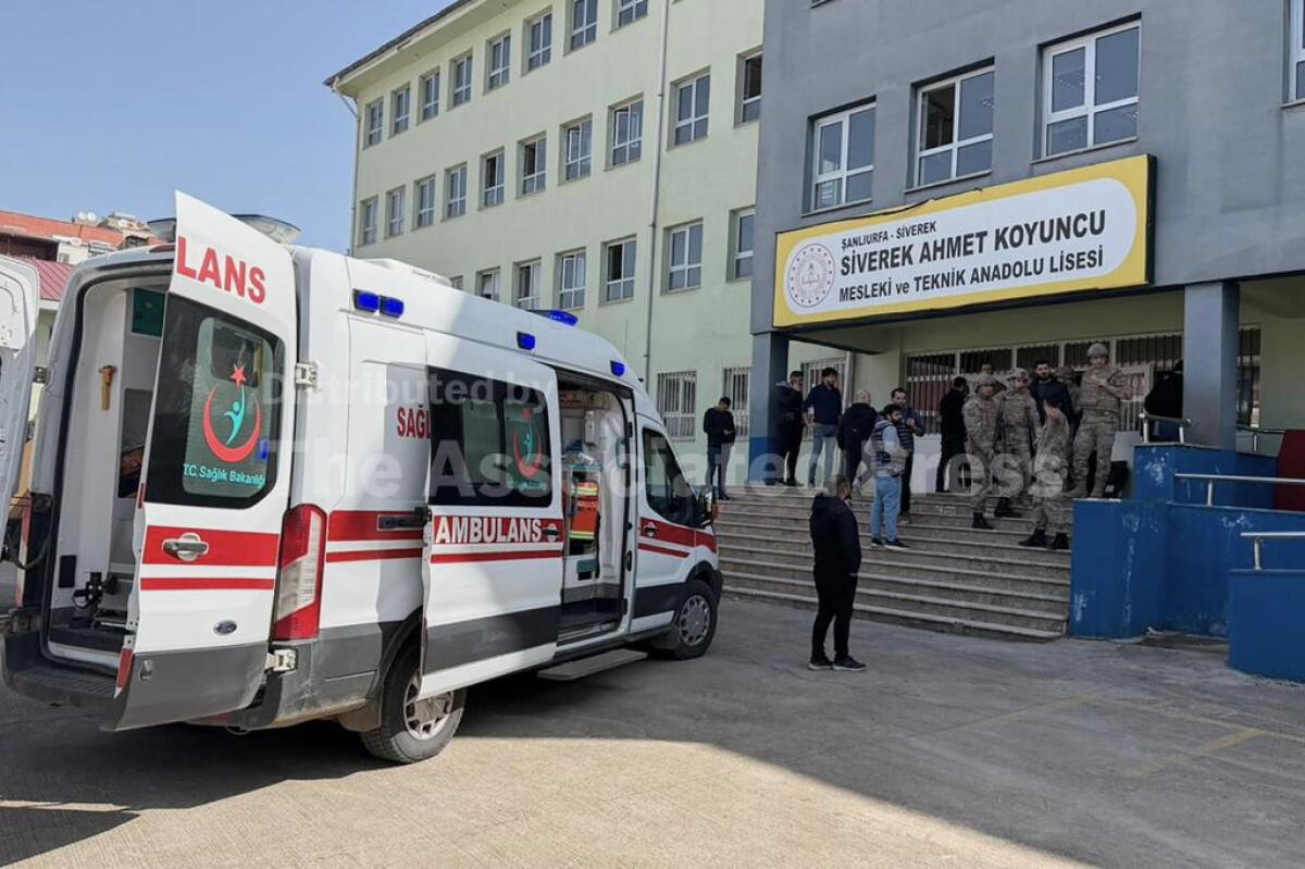 Turkish security forces and emergency staff stand at the courtyard of a high school where an assailant opened fire