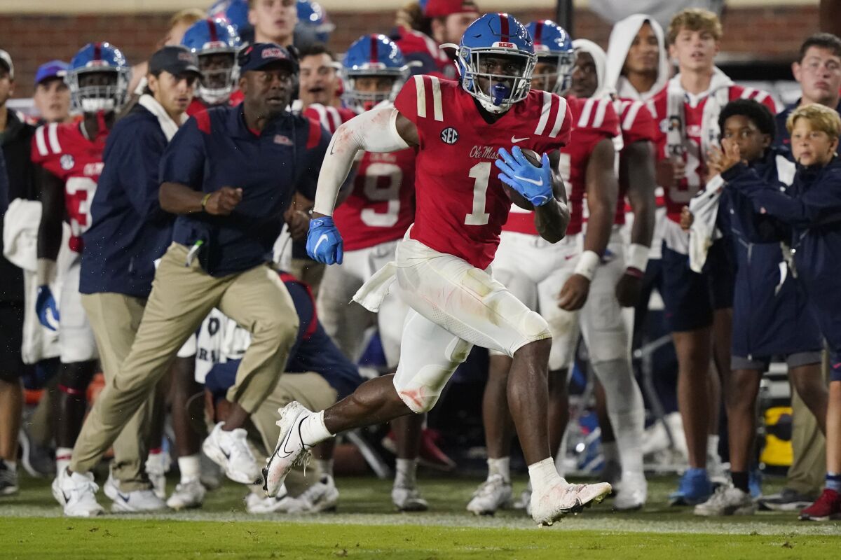 Mississippi wide receiver Jonathan Mingo (1) runs along the sideline after catching a pass against Tulane during the first half of an NCAA college football game Saturday, Sept. 18, 2021, in Oxford, Miss. (AP Photo/Rogelio V. Solis)