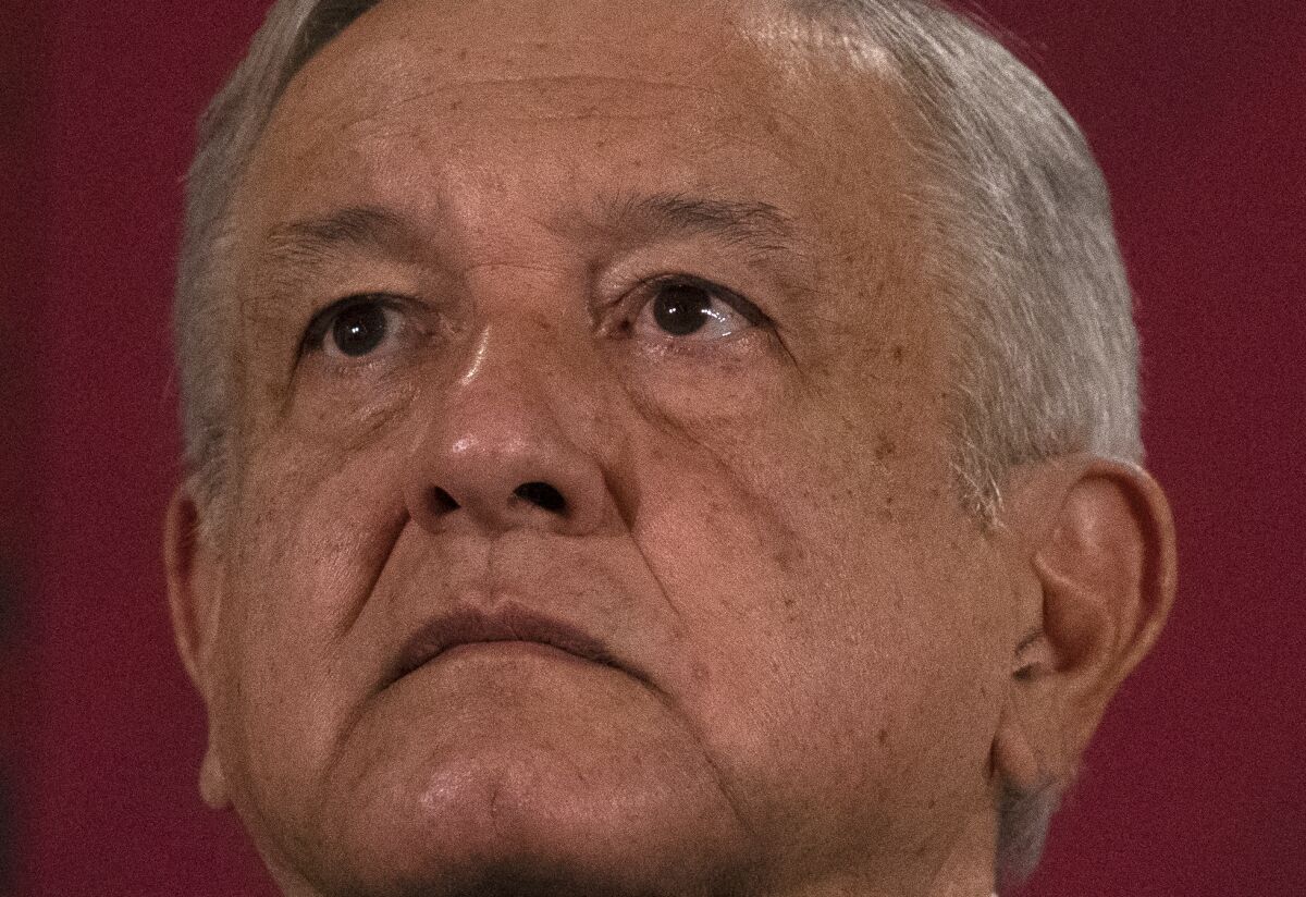 Mexico's President Andres Manuel Lopez Obrador looks up during his daily, morning news conference at the presidential palace, Palacio Nacional, in Mexico City, Monday, July 13, 2020. (AP Photo/Marco Ugarte)