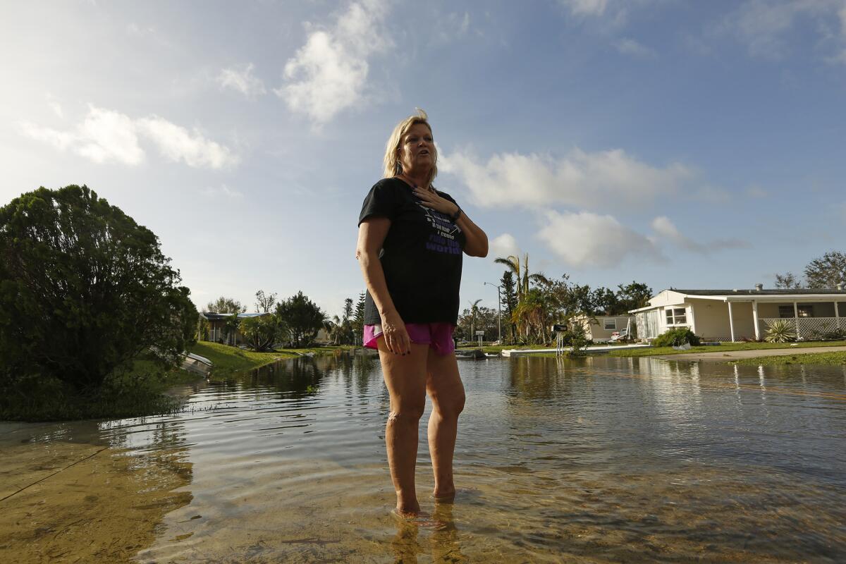 Sue Przybylski stands in shallow water near her home in Naples, Fla.