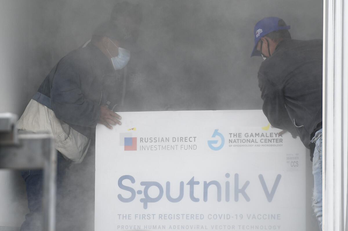 Workers with a shipment of the Russian COVID-19 vaccine Sputnik V