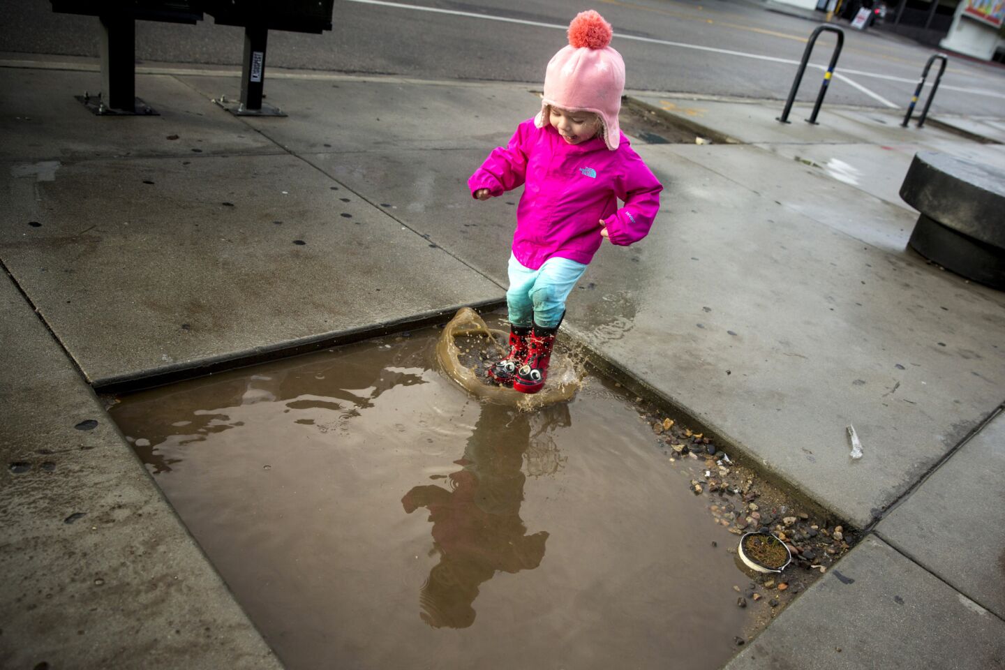Valentina Flores,2, of City of Commerce, enjoys a puddle in the Little Tokyo area of downtown Los Angeles, Calif.