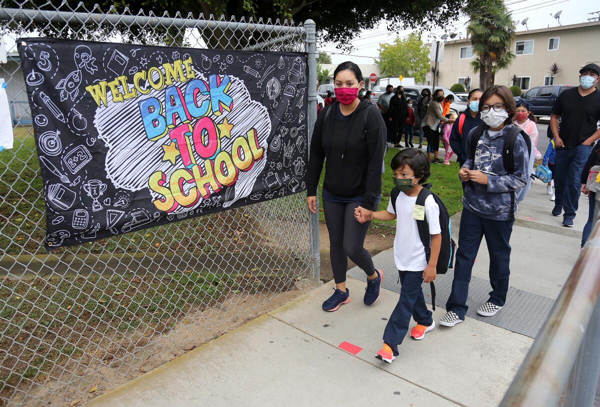 Parents lead their kids to the first day of school at Whittier Elementary.