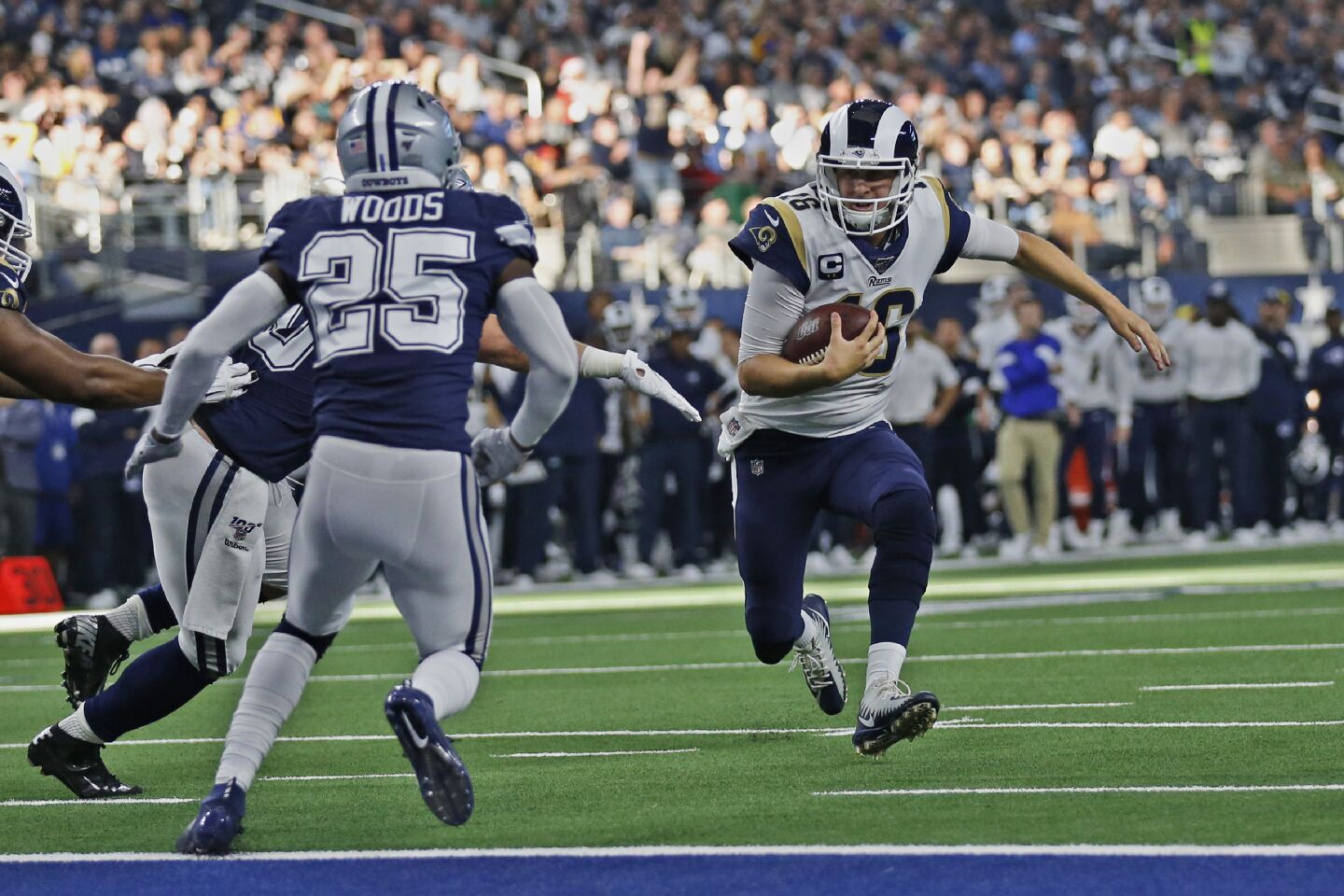 Rams quarterback Jared Goff is stopped short of the goal line by Dallas Cowboys outside linebacker Sean Lee, left, as safety Xavier Woods moves in.
