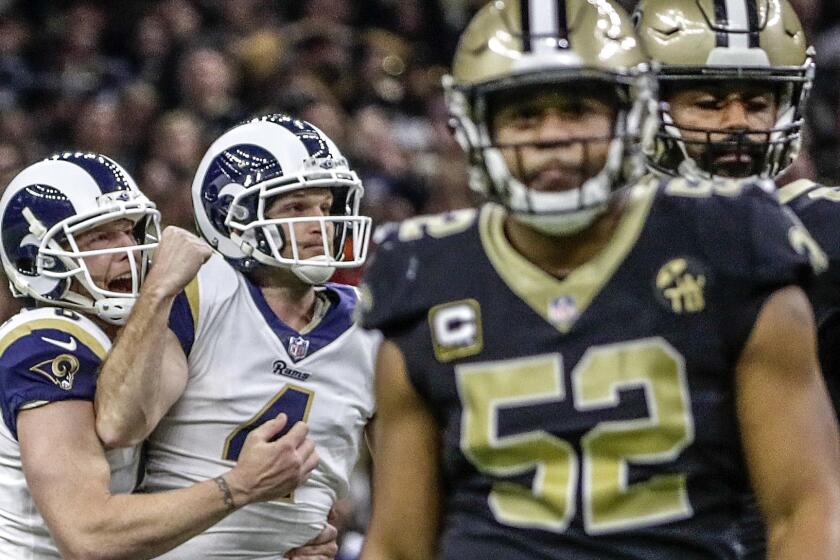 NEW ORLEANS, LOUISIANA, SUNDAY, JANUARY 20, 2019 - Kicker Greg Zuerlein is embraced by punter Johnny Hekker after hitting a 57-yard field goal in overtime to beat the Saints 26-23 in the NFC Championship at the Superdome. (Robert Gauthier/Los Angeles Times)