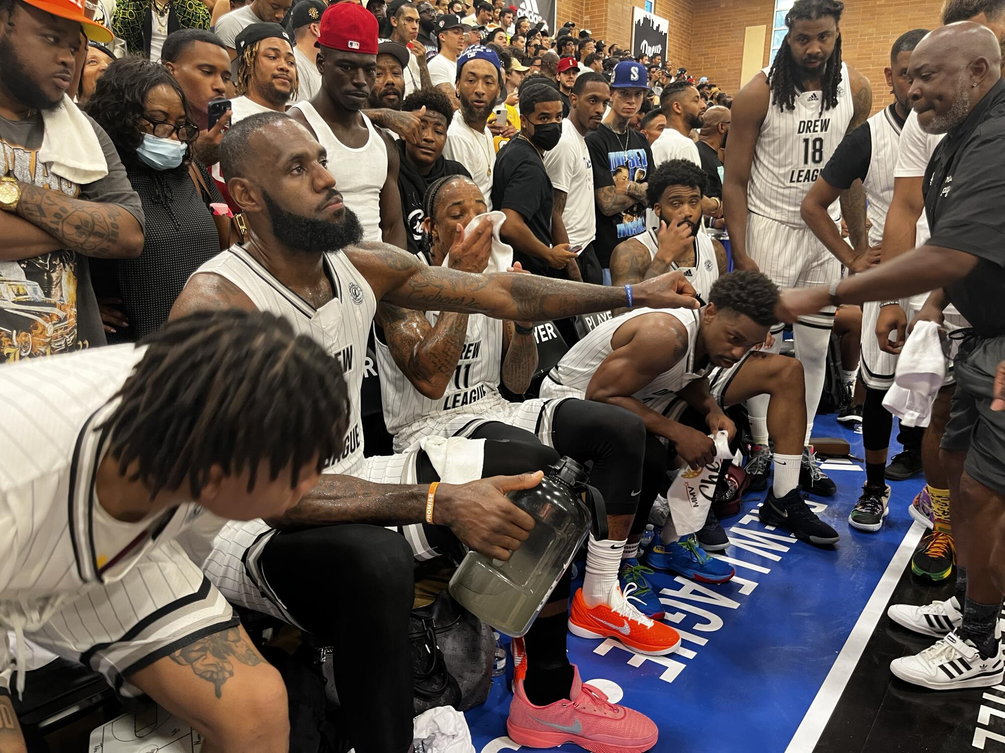 LeBron James on the bench while participating in a Drew League game.