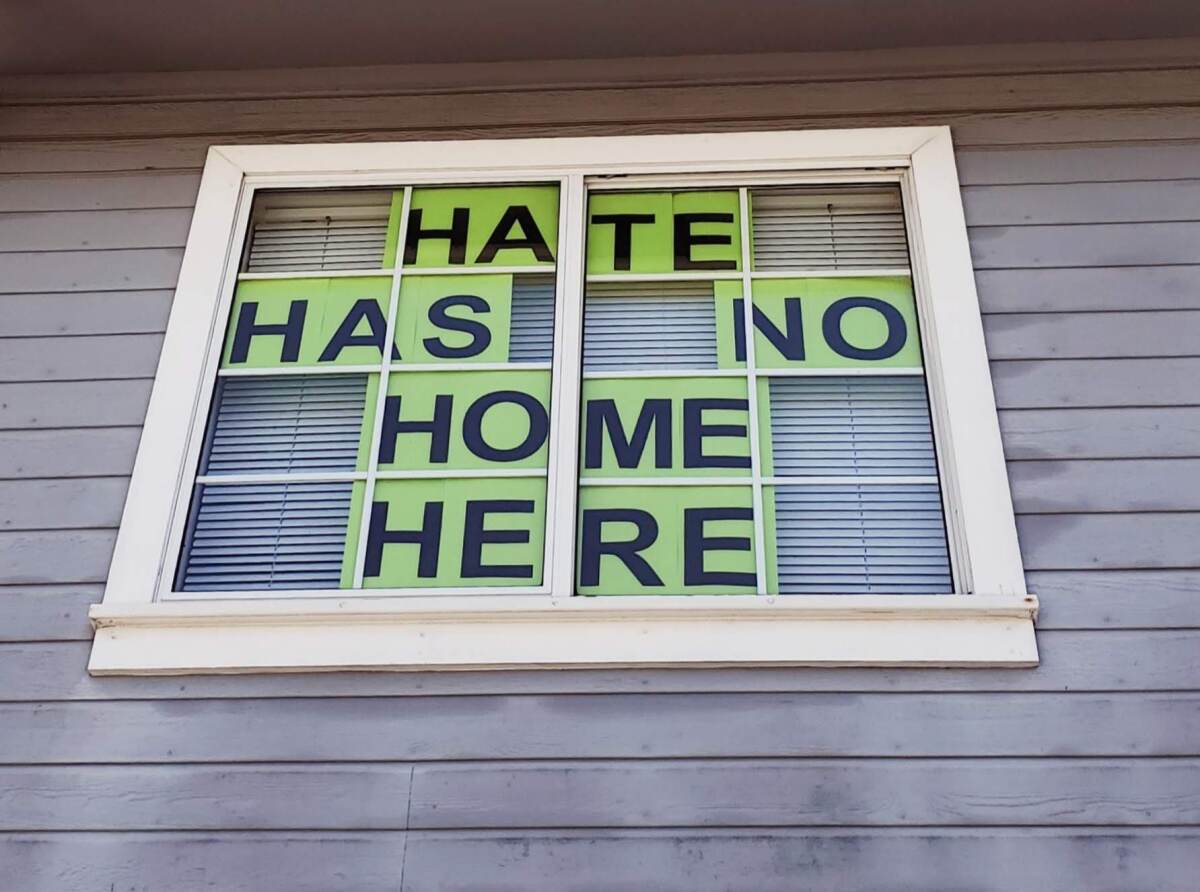 A window sign in Santee shows a response to a recent incident where a man wore a KKK hood inside a grocery store.