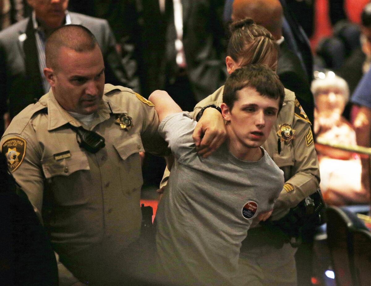 Police remove Michael Sandford from a Donald Trump rally in Las Vegas in June.