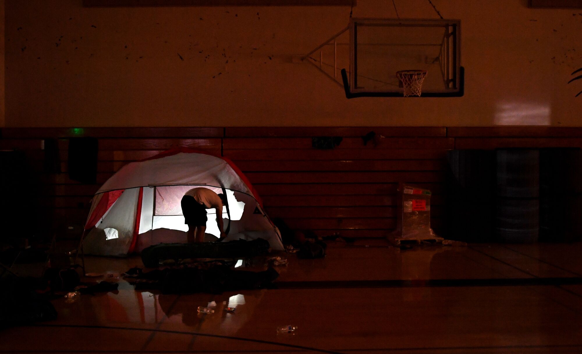 A Paradise football player gets ready to spend the night in the school's gymnasium during training camp.