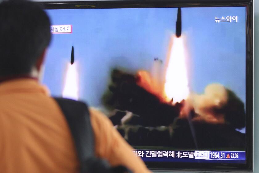 A man in Seoul watches TV news showing North Korea's launch of two medium-range ballistic missiles.