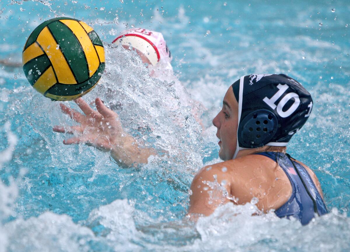 Crescenta Valley girls water polo player Kyra Freemon wins the ball in game vs. Burbank Burroughs, at home in La Crescenta on Thursday, Jan. 16, 2020.