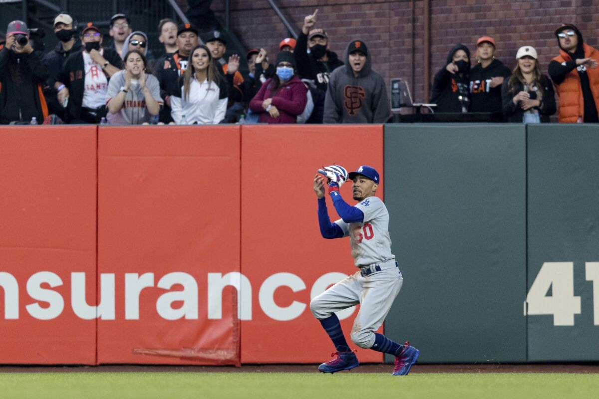 Dodgers right fielder Mookie Betts catches a deep fly ball against the San Francisco Giants.