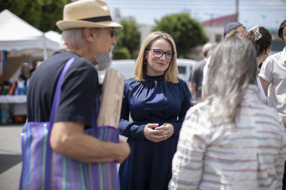 Lindsey Horvath speaks with shoppers at Melrose Place Farmers Market on April 10.