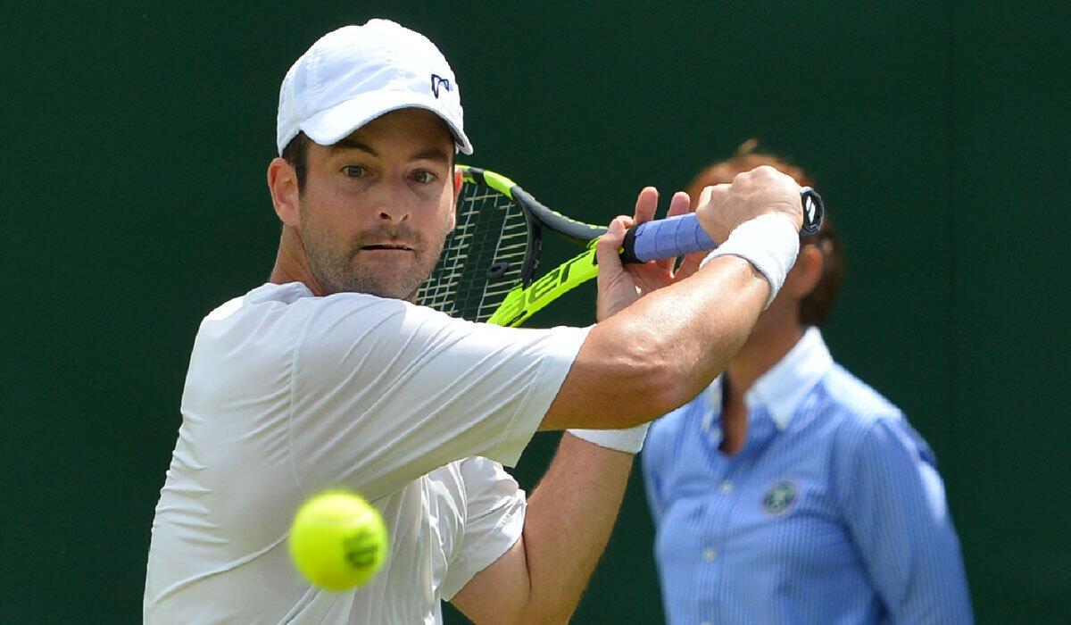 Brian Baker returns against Marin Cilic during the first round at Wimbledon.