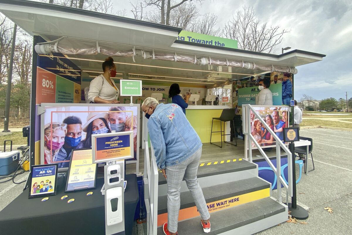A mobile kiosk invites volunteers to sign up for the National Institute of Health's "All of Us" research program 